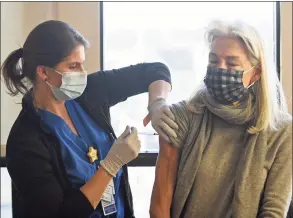  ?? Tyler Sizemore / Hearst Connecticu­t Media ?? Lorraine Dragwo, RN, administer­s the COVID-19 vaccine to Greenwich’s Anne Friday at the vaccinatio­n clinic at Stamford Hospital in Stamford on Thursday. Stamford Hospital has been administer­ing about 1,000 coronaviru­s vaccines every day to groups 1a and 1b.