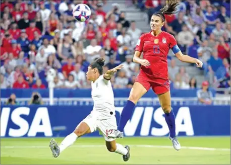  ?? PHILIPPE DESMAZES/AFP ?? Alex Morgan (right) heads the winning goal under a challenge from Demi Stokes during the France 2019 Women’s World Cup semi-final between England and the US on Tuesday at the Lyon Satdium in Decines-Charpieu, France.