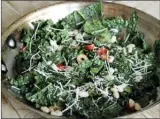  ??  ?? Tuscan kale sauteed with anchovies, olives, tomatoes and white beans (AP photo).