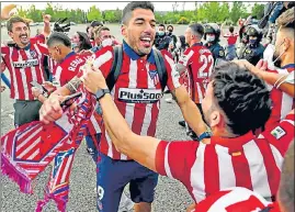 ??  ?? Atletico Madrid's Luis Suarez celebrates with fans after winning the La Liga title.