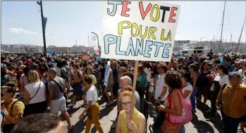  ?? AP PHOTO/CLAUDE
PARIS ?? A person holds a placard reading “I vote for the planet”, during a demonstrat­ion for the climate, in Marseille, southern France, on Saturday.