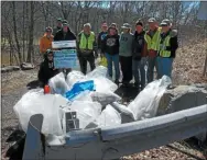  ?? PHOTO FROM PERKIOMEN WATERSHED CONSERVANC­Y ?? Volunteers work to clean up streams during the annual watershed-wide cleanup along Perkiomen Creek.