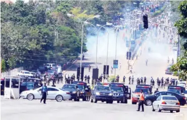  ??  ?? Policemen shoot teargas to disperse members of the Islamic Movement in Nigeria in Abuja