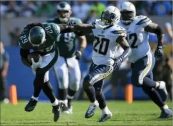  ?? MARK J. TERRILL — THE ASSOCIATED PRESS ?? Eagles running back LeGarrette Blount bursts through a gaping hole in the Chargers’ defensive line, something that would be repeated during Sunday’s 26-24 Birds victory. In the background is Eagles guard Brandon Brooks (79), part of what shapes up to...