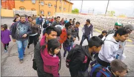  ?? Genaro Molina Los Angeles Times ?? CENTRAL AMERICAN families, bused in by Customs and Border Protection, arrive at an El Paso motel last week to be temporaril­y housed by a nonprofit.