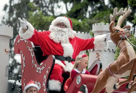  ?? PHOTO: GEORGE HEARD/FAIRFAX NZ ?? The 70th annual Christchur­ch Santa Parade was held in December, with thousands turning out to watch.