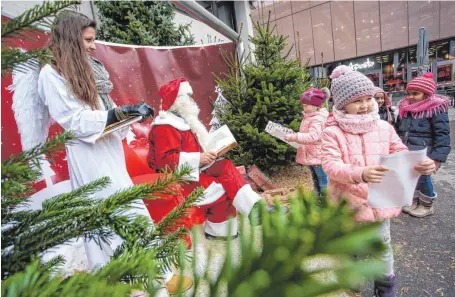  ?? FOTO: THOMAS SIEDLER ?? Zahlreiche Kinder haben am Mittwoch dem Weihnachts­mann ihre Wünsche verraten, darunter auch Sophie (vorne rechts), die mit ihrem Wunschzett­el glücklich zu ihrer Mama geht.