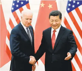  ?? LINTAO ZHANG/GETTY ?? Chinese President Xi Jinping shakes hands with U.S Vice President Joe Biden on Dec. 4, 2013.