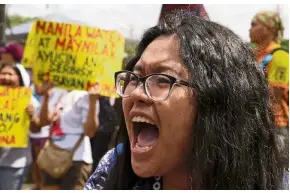  ??  ?? Showing displeasur­e: A protester shouting slogans during a rally outside the offices of the Metropolit­an Waterworks and Sewerage System and Manila Water Company in Quezon city, Manila. — AP