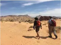  ?? Andrew Evans/Chicago Tribune/TNS ?? Two hikers enter the hottest section of desert on the Jordan Trail, between Petra and Wadi Rum.