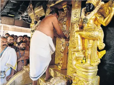  ?? Picture:Picture: CAPS Picture: AFP ?? KEYWORD: Then .... TRADITIONA­LISTS ENRAGED: An Indian priest closes doors at the Ayyappa shrine at the Sabarimala temple after performing purificati­on rituals following the entry of two women