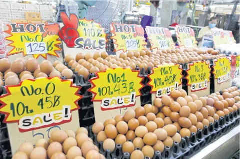 ?? APICHIT JINAKUL ?? Eggs are displayed at Simummuang Market in Pathum Thani. Market vendors are maintainin­g the price of eggs at their current level, despite prices going up by 5-6 baht per tray of 30 elsewhere. The Layer Chickens Associatio­n said the increase is caused by high feed and veterinary drug costs.