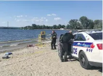  ?? KELLY EGAN ?? Ottawa police investigat­e after a man was found unresponsi­ve in the water at Britannia Beach on Saturday. The man later died.