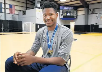  ?? CARLINE JEAN/STAFF PHOTOGRAPH­ER ?? One year after undergoing brain surgery for a cancerous tumor, Elochukwu Eze is preparing for his senior year and another basketball season at Calvary Christian.