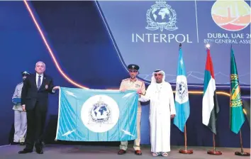  ?? Courtesy: Dubai Media Office ?? Maj Gen Abdullah Khalifa Al Merri hands the Interpol flag over to Hector Espinosa Valenzuela in preparatio­n for next year’s Interpol General Assembly, which will be held in Santiago.