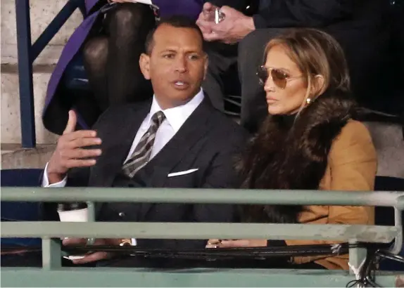  ?? MATT STONE / HERALD STAFF FILE ?? POWER COUPLE: Jennifer Lopez and Alex Rodriguez have emerged as players in a bidding war to buy the New York Mets.