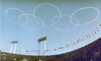  ??  ?? Blue Impulse, the Japanese air force’s aerobatic team, draw Olympic rings in the sky during the 1964 opening ceremony. Photograph: Kyodo/Reuters