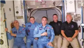  ?? NASA VIA AP ?? Bob Behnken and Doug Hurley, far right, joining the the crew at the Internatio­nal Space Station, after the SpaceX Dragon capsule pulled up to the station and docked Sunday.