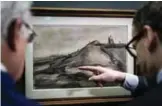  ?? — AFP ?? Dutch businessma­n John Fentener van Vlissingen (left) and director of the Van Gogh Museum in Amsterdam Axel Ruger (right) look at a recently discovered drawing dated from 1886 by Dutch painter Vincent Van Gogh entitled ‘Montmartre Hill with Quarry’ (De...