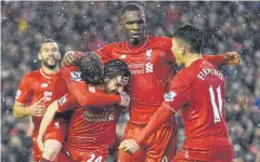  ?? AFP ?? Liverpool’s Joe Allen, second left, celebrates with teammates.