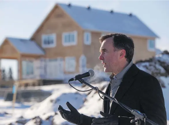  ?? AMBER BRACKEN/THE CANADIAN PRESS ?? Finance Minister Bill Morneau announced Monday that Fort McMurray residents will get a compensati­on package from drywall duties, and minimum import prices would be cut by over 32 per cent. “We’re pleased to be able to help people out,” said Morneau....