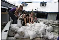  ?? AP/CHRIS O’MEARA ?? Krystal Day(left) of Homosassa, Fla., leads a sandbag assembly line Tuesday at the Old Port Cove restaurant in Ozello on the central Florida Gulf Coast.