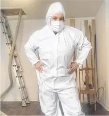  ?? CONTRIBUTE­D ?? Emilie Chiasson is suited up in preparatio­n for blowing insulation into her attic.