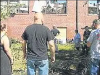  ?? MEDIANEWS GROUP FILE PHOTO ?? Residents inspect damage after fire roared through Our Lady of Angels School in Ridley.