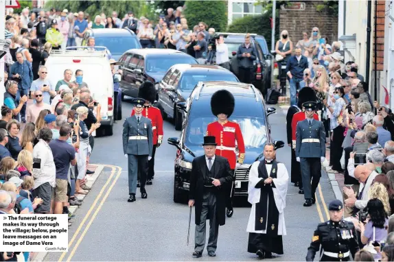  ?? Gareth Fuller ?? The funeral cortege makes its way through the village; below, people leave messages on an image of Dame Vera