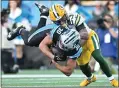  ?? GRANT HALVERSON — GETTY IMAGES ?? The Packers’ Jaire Alexander, right, tackles the Panthers’ Chuba Hubbard during the fourth quarter at Bank of America Stadium on Sunday in Charlotte, North Carolina.