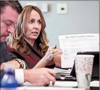  ?? Arkansas Democrat-Gazette/MITCHELL PE MASILUN ?? The newly elected chairman of the Senate Ethics Committee, Sen. Missy Irvin, holds up the draft of the committee’s work plan for others to see during their inaugural meeting at the state Capitol on Thursday. Next to her is Sen. Jason Rapert.