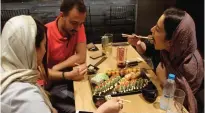  ??  ?? Iranians eat at a high-end French sushi chain.