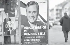  ??  ?? A woman passes presidenti­al election campaign posters of Hofer and Van der Bellen, who is supported by the Greens, in Vienna, Austria. Poster read ‘for Austria with heart and soul. So help me God’. — Reuters photo