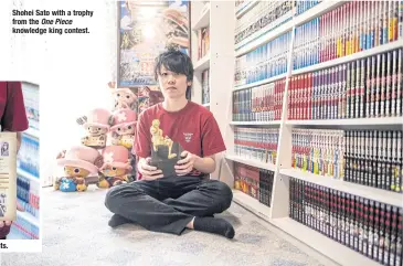  ?? ?? Shohei Sato with a trophy fromthe One Piece knowledge king contest.