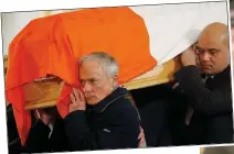  ?? ?? FAREWELL: Richard Bruton helps carry his brother’s tricolour-draped coffin into the church