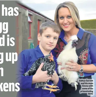  ??  ?? Joshua Garrett and his mum Emma with some of his prizewinni­ng
birds