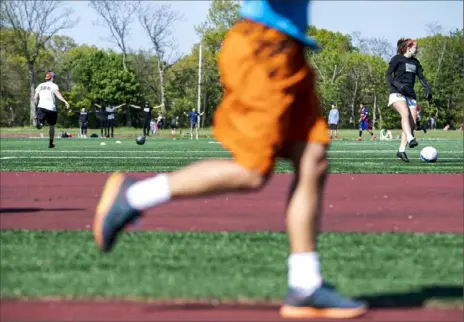  ?? Emily Matthews/Post-Gazette photos ?? People run, exercise and play soccer on the field Wednesday at Schenley Oval Sportsplex in Oakland’s Schenley Park.