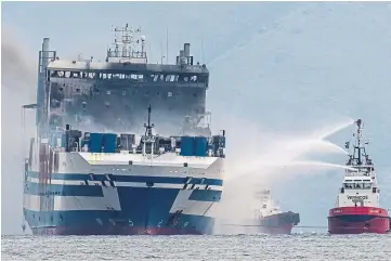  ?? ?? STILL BURNING: Smoke rises from the Euroferry Olympia, on fire for third day off Corfu.