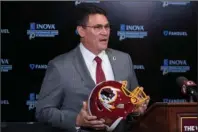  ?? The Associated Press ?? A TIME TO MOVE FORWARD: Washington Redskins head coach Ron Rivera holds up a helmet during a Jan. 2 news conference at the team’s NFL training facility in Ashburn, Va. The Redskins are undergoing what the team calls a “thorough review” of the nickname. In a statement released Friday the team says it has been talking to the NFL for weeks about the subject. Owner Dan Snyder says the process will include input from alumni, sponsors, the league, community and members of the organizati­on. FedEx on Thursday called for the team to change its name, and Nike appeared to remove all Redskins gear from its online store.