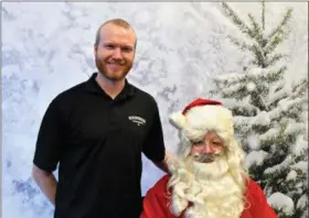  ??  ?? Matt Taylor, operations director of the Roxborough Developmen­t Corp., poses with Santa.