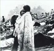  ?? ASSOCIATED PRESS ?? In this August 1969 file photo, a couple hugs during the Woodstock Music and Art Festival in Bethel, N.Y.