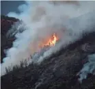  ?? NOAH BERGER/AP ?? Flames from the Ferguson Fire burn down a hillside in Mariposa County Calif., near Yosemite National Park on Sunday.