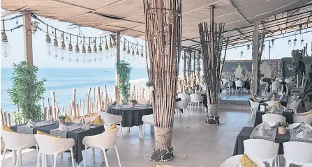  ?? ?? Empty tables are pictured in a restaurant in Dakar.