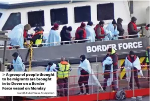  ?? Gareth Fuller/Press Associatio­n ?? > A group of people thought to be migrants are brought in to Dover on a Border
Force vessel on Monday