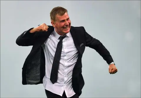  ??  ?? A delighted Stephen Kenny runs to share his delight with supporters following Dundalk’s FAI Cup Final success on Sunday.