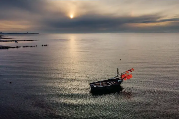 ??  ?? A small fisher boat bobs up and down on the Baltic Sea in Sierksdorf, northern Germany, as the sun rises yesterday. Photo: AP