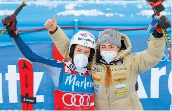  ??  ?? Bassino (left), third in women’s giant slalom at the alpine ski World Cup, celebrates with Sofia Goggia, in San Vigilio di Marebbe, Italy, on January 26.