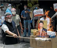  ?? AP ?? Indian traders burn Chinese products and a poster of President Xi Jinping during a protest in New Delhi this week. China said the Galwan Valley in the Himalayan border region where Chinese and Indian troops engaged in a deadly brawl last week falls entirely within China.