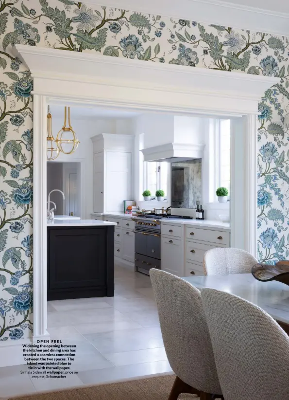  ?? ?? OPEN FEEL Widening the opening between the kitchen and dining area has created a seamless connection between the two spaces. The island was painted blue to tie in with the wallpaper. Sinhala Sidewall wallpaper, price on request, Schumacher