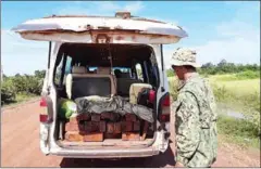  ?? SUPPLIED ?? Officials inspect and seize illegally logged timber after a bust last week in Kampong Thom province.